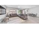 Open-concept living room showcases a comfortable sectional, dining area, and sliding glass doors to the backyard at 1104 E Tekoa Ave, Gilbert, AZ 85298