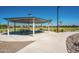 Covered picnic area with multiple tables, walking path, and lush landscaping for Gathering gatherings and outdoor enjoyment at 1104 E Tekoa Ave, Gilbert, AZ 85298
