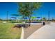 Community playground with colorful sunshades, exercise equipment, walking paths, and ample green space for recreational activities at 1104 E Tekoa Ave, Gilbert, AZ 85298