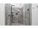 This tiled walk-in shower features a shower head, seating, and recessed shelving for toiletries at 1104 E Tekoa Ave, Gilbert, AZ 85298