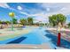 Gathering-friendly splash pad with various water features, shaded seating, and colorful play structures for outdoor fun and entertainment at 1104 E Tekoa Ave, Gilbert, AZ 85298