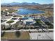 Aerial view of a lake community with walking paths and recreational facilities at 11562 W Levi Dr, Avondale, AZ 85323