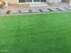 Backyard with synthetic grass and pavers; perfect for low-maintenance living at 11562 W Levi Dr, Avondale, AZ 85323