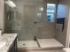 Modern walk-in shower with glass enclosure and tiled walls, offering a spa-like experience at 11562 W Levi Dr, Avondale, AZ 85323