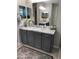 Elegant bathroom with a granite-topped vanity and decorative mirrors at 11562 W Levi Dr, Avondale, AZ 85323