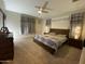 Well-lit bedroom featuring a ceiling fan and a warm, inviting atmosphere at 11562 W Levi Dr, Avondale, AZ 85323