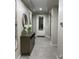 Elegant hallway with ceramic floors, console table, decorative mirror, and light-filled entryway at 11562 W Levi Dr, Avondale, AZ 85323