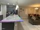 Open kitchen features a large island with grey cabinets and granite countertops at 11562 W Levi Dr, Avondale, AZ 85323