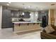 Modern kitchen with grey cabinets, stainless steel appliances, and a large center island at 11562 W Levi Dr, Avondale, AZ 85323