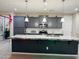 Modern kitchen features a large island with granite countertops, stainless steel appliances, and gray cabinets at 11562 W Levi Dr, Avondale, AZ 85323
