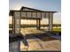 Modern pavilion with metal roof overlooking a serene lake at 11562 W Levi Dr, Avondale, AZ 85323