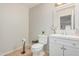 Clean half-bathroom featuring a modern vanity, sleek mirror, and neutral color palette, offering a refreshing space at 12376 W Hazelwood St, Avondale, AZ 85392