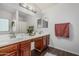 Bathroom features a double sink vanity with dark wood cabinets at 12376 W Hazelwood St, Avondale, AZ 85392