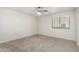 Bedroom with neutral walls, carpeted floors, a ceiling fan, and a window at 12376 W Hazelwood St, Avondale, AZ 85392