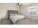 Bedroom featuring carpeted floors, a ceiling fan and a window at 12376 W Hazelwood St, Avondale, AZ 85392