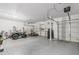 Spacious three-car garage with ample room for vehicles, ATVs, and storage, offering convenience and functionality at 12376 W Hazelwood St, Avondale, AZ 85392