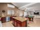 Open kitchen features granite countertops, stainless steel appliances, and a view to the pool table in the Gathering room at 12376 W Hazelwood St, Avondale, AZ 85392