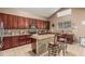 Spacious kitchen with granite countertops, stainless steel appliances, and a breakfast bar with seating at 12376 W Hazelwood St, Avondale, AZ 85392