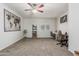 Comfortable living room featuring plush carpeting, a ceiling fan, and ample space for versatile use at 12376 W Hazelwood St, Avondale, AZ 85392