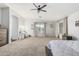 Spacious main bedroom featuring carpeted flooring, a ceiling fan, and windows for natural light at 12376 W Hazelwood St, Avondale, AZ 85392