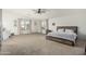 Spacious main bedroom provides comfort and style with large windows, soft carpeting, and a relaxing atmosphere at 12376 W Hazelwood St, Avondale, AZ 85392