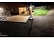 Nighttime view of a spacious backyard with gravel landscaping and playground at 12950 W Cassia Trl, Peoria, AZ 85383