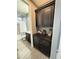 Bathroom with dark cabinets, stone countertops, and a combination tub and shower at 12950 W Cassia Trl, Peoria, AZ 85383