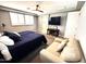 Spacious bedroom featuring a ceiling fan, large bed, and plantation shutters at 12950 W Cassia Trl, Peoria, AZ 85383