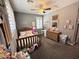 Comfortable bedroom featuring carpet, ceiling fan, natural light, and a cozy bed at 12950 W Cassia Trl, Peoria, AZ 85383