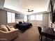 Bright bedroom with a ceiling fan, plantation shutters, and a cozy sitting area at 12950 W Cassia Trl, Peoria, AZ 85383
