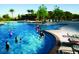 Resort-style community pool with children playing and lush landscaping at 12950 W Cassia Trl, Peoria, AZ 85383