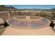 Outdoor community sundial and seating area with desert and mountain views, perfect for relaxing or gathering at 12950 W Cassia Trl, Peoria, AZ 85383