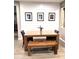 Charming dining area features a wooden table with bench and three bicycle-themed art pieces at 12950 W Cassia Trl, Peoria, AZ 85383