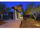 Inviting community entrance with stone pillars and desert landscaping at dusk at 12950 W Cassia Trl, Peoria, AZ 85383