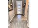 Contemporary front entry with stylish flooring, a modern front door, and decorative wall art at 12950 W Cassia Trl, Peoria, AZ 85383
