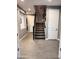 Inviting foyer featuring wood-look tile flooring and a staircase with dark wood banister at 12950 W Cassia Trl, Peoria, AZ 85383