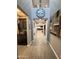 Welcoming hallway with tile floors, modern art, and a glimpse into the open-concept kitchen and living areas at 12950 W Cassia Trl, Peoria, AZ 85383