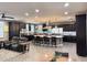 Spacious open-concept kitchen with a large island, dark cabinetry, and stainless steel appliances at 12950 W Cassia Trl, Peoria, AZ 85383