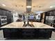Open-concept kitchen features a large island with cooktop and ample storage space at 12950 W Cassia Trl, Peoria, AZ 85383