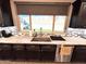 Well-appointed kitchen with granite countertops, mosaic backsplash, and stainless steel sink at 12950 W Cassia Trl, Peoria, AZ 85383