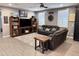 Cozy living room featuring comfortable seating, built-in bookshelves, and a large TV at 12950 W Cassia Trl, Peoria, AZ 85383