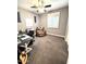 Home office features a ceiling fan, carpet flooring, and natural light at 12950 W Cassia Trl, Peoria, AZ 85383