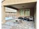 Outdoor patio with brick flooring and a seating area. There is a playing area in the backyard beyond the patio at 12950 W Cassia Trl, Peoria, AZ 85383