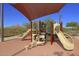 Colorful community playground with slides and climbing structures against a mountain backdrop at 12950 W Cassia Trl, Peoria, AZ 85383