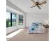 Bright bedroom with a bay window, ceiling fan, and neutral carpeting at 14151 W Yosemite Dr, Sun City West, AZ 85375