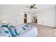 Bedroom with a ceiling fan, neutral carpeting, and access to the kitchen and bathroom at 14151 W Yosemite Dr, Sun City West, AZ 85375
