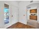Bright foyer features hard wood floors and natural light, and leads into a hallway with built in cabinets at 14151 W Yosemite Dr, Sun City West, AZ 85375