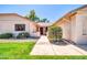 Inviting front entrance with a well-manicured lawn and mature landscaping leading to a warm and welcoming front door at 14151 W Yosemite Dr, Sun City West, AZ 85375