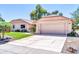 Attractive one-story home featuring a spacious driveway, manicured landscaping, and an attached two-car garage at 14151 W Yosemite Dr, Sun City West, AZ 85375