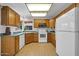 Spacious kitchen with ample cabinet space, white appliances, and a view of the backyard at 14151 W Yosemite Dr, Sun City West, AZ 85375